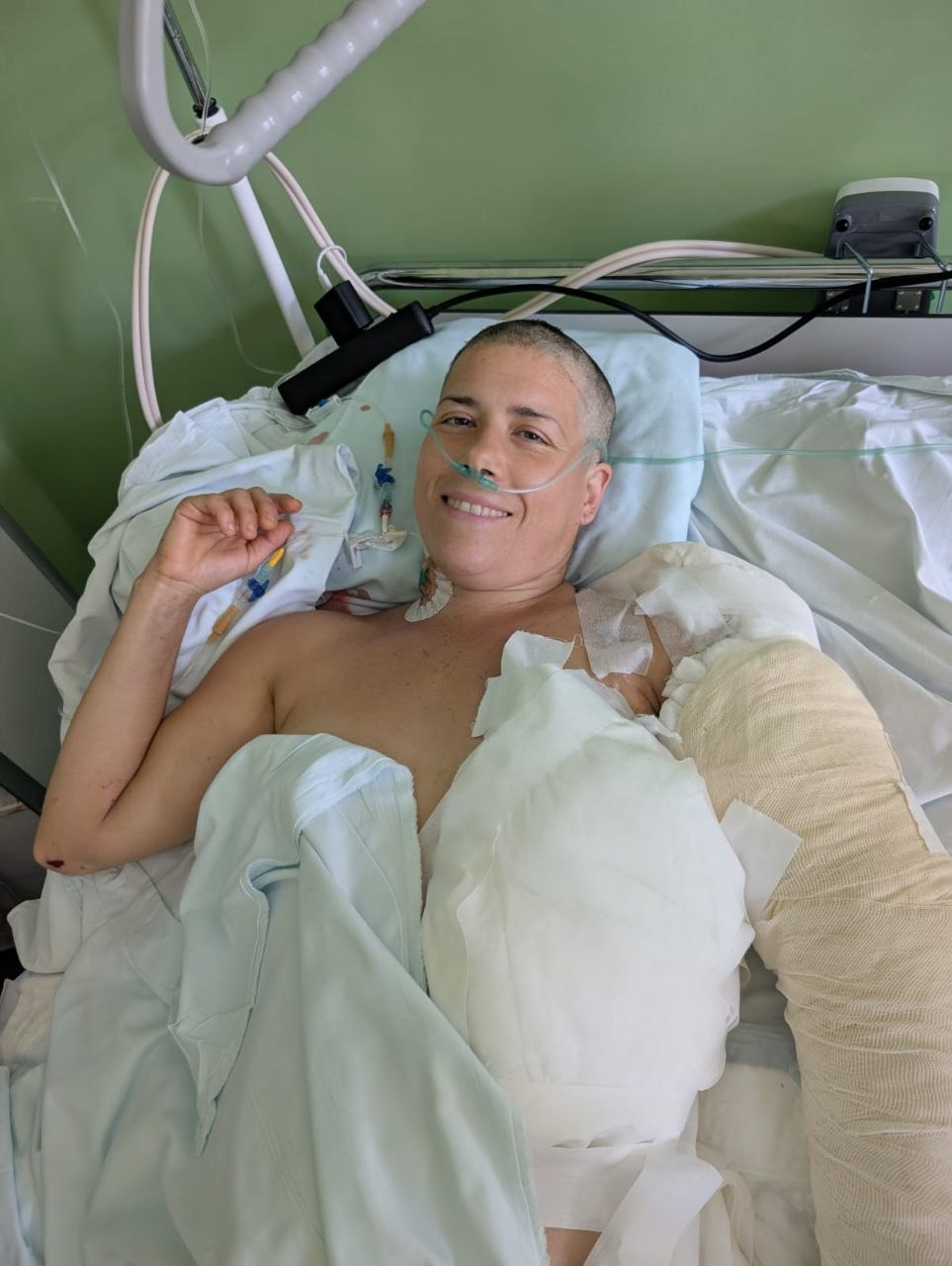 Ana smiling from her hospital bed despite her serious injuries